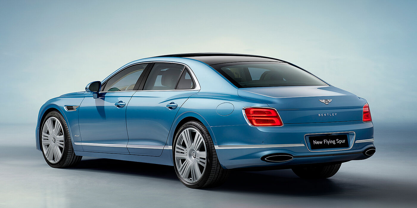 Gohm Sportwagen GmbH | Bentley Singen New Bentley Flying Spur Azure sedan rear view in Light windsor blue by Mulliner paint with 22 inch Azure wheels and chrome exterior details