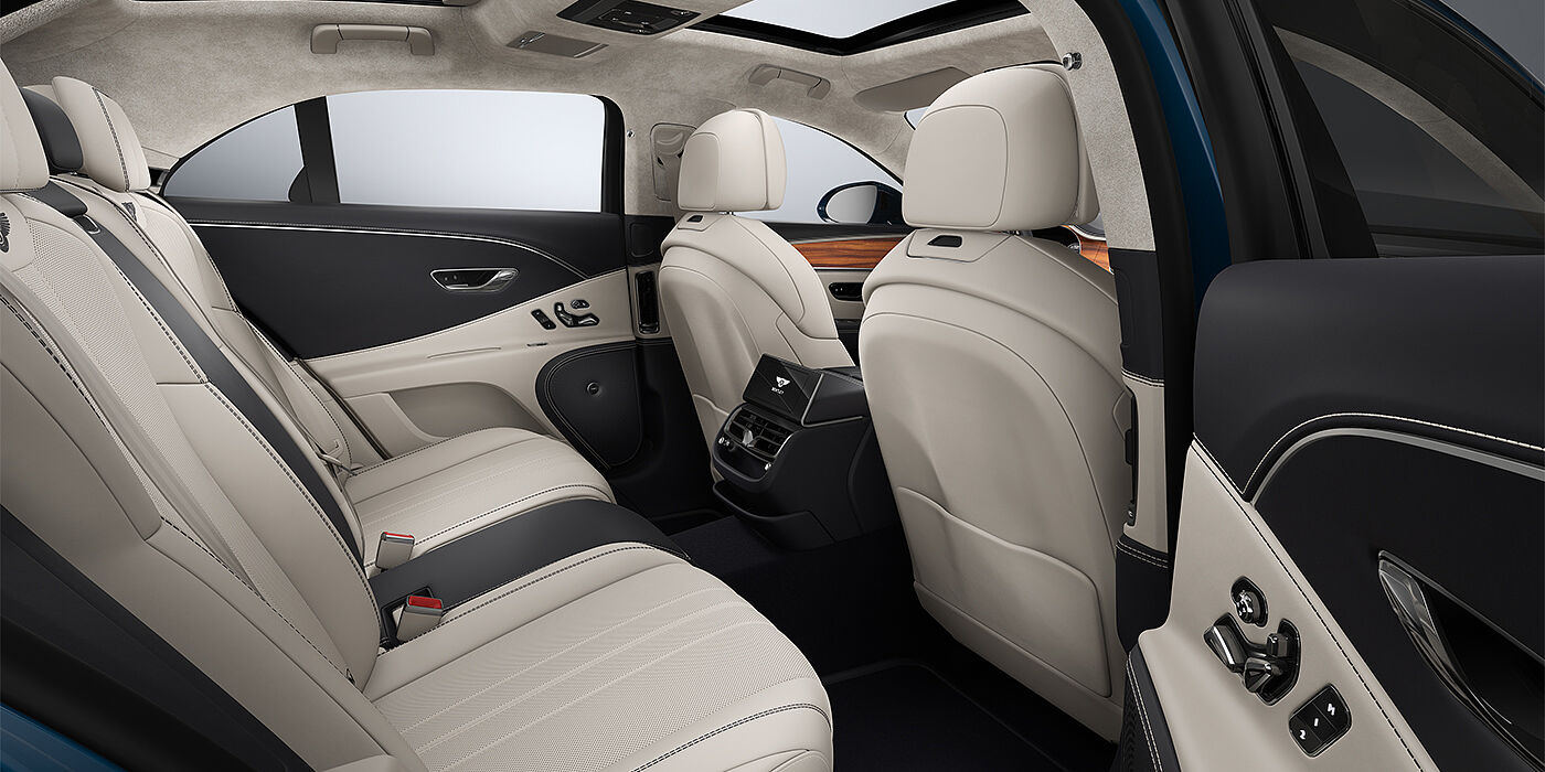 Gohm Sportwagen GmbH | Bentley Singen New Bentley Flying Spur sedan rear interior in Linen and Imperial Blue hides with Open Pore Koa veneer