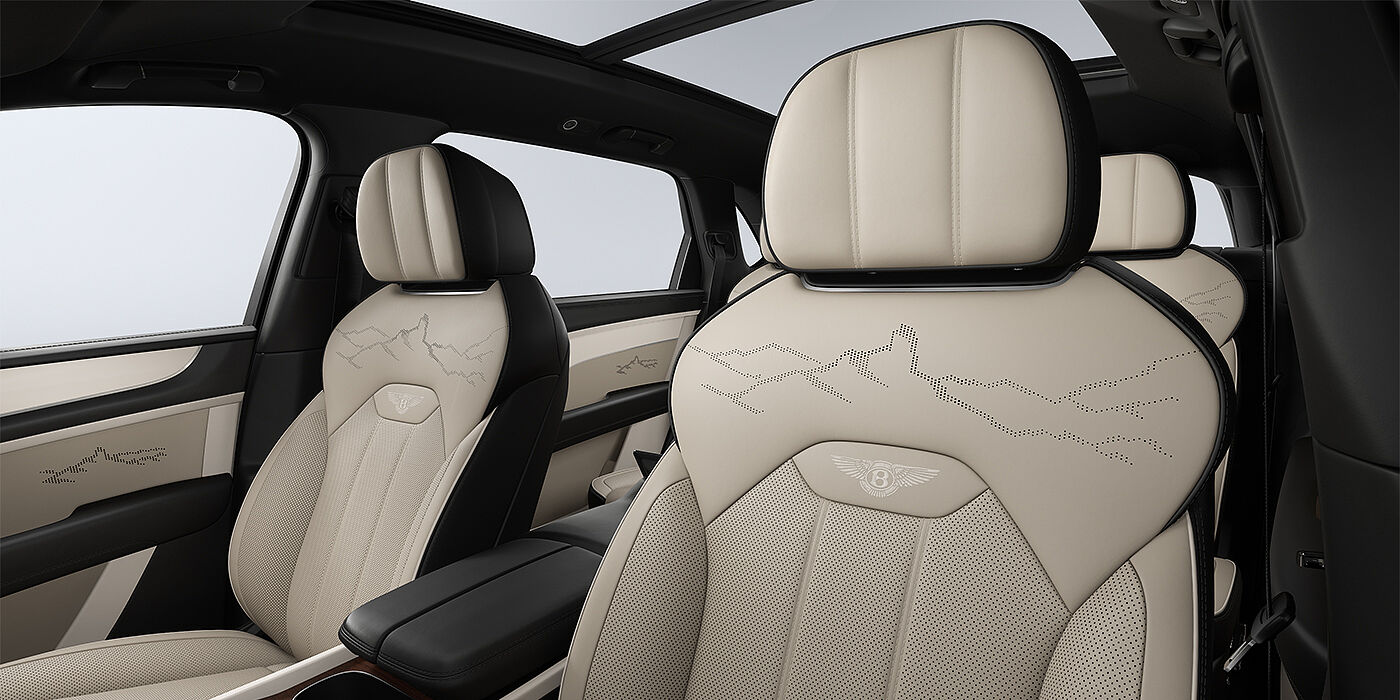 Gohm Sportwagen GmbH | Bentley Singen Bentayga EWB Artenara Edition SUV front seats in Portand and Beluga Black hides and Artenara stitch detail