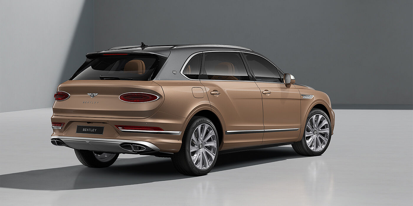 Gohm Sportwagen GmbH | Bentley Singen Bentley Bentayga EWB Mulliner SUV in Magnetic and Rose Gold paint and 22" Mulliner wheels rear ¾