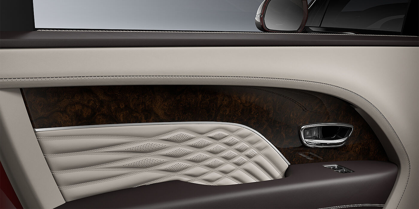 Gohm Sportwagen GmbH | Bentley Singen Bentley Bentayga EWB Azure SUV door interior detail in Linen and Burnt Oak hides with Dark Stained Burr Walnut veneer