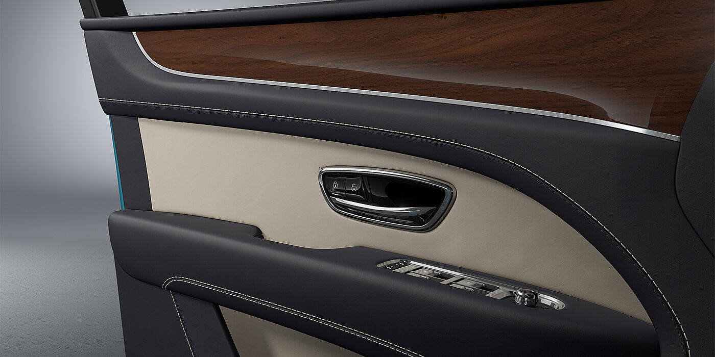 Gohm Sportwagen GmbH | Bentley Singen Bentley Bentayga EWB SUV door interior detail in Portland and Imperial Blue hides with Crown Cut Walnut veneer