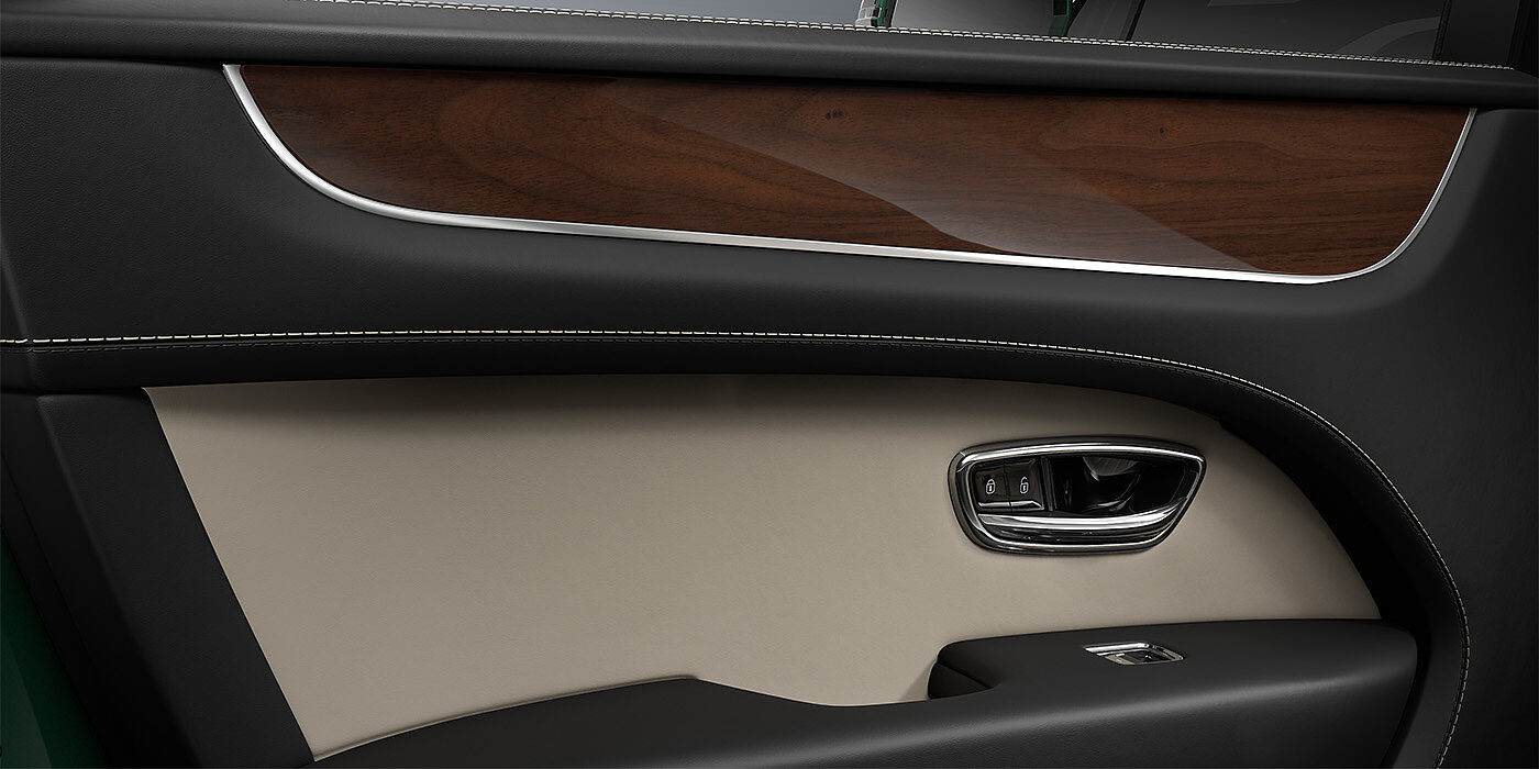 Gohm Sportwagen GmbH | Bentley Singen Bentley Bentayga SUV door interior detail in Portland and Beluga black hides with Crown Cut Walnut veneer