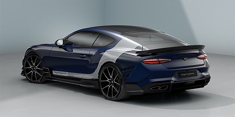 Gohm Sportwagen GmbH | Bentley Singen Bentley Supersports rear three quarter in "Skies" Design theme with Electric Blue paint finish and Arctica white and Oxford blue paint stripes across the rear haunch.