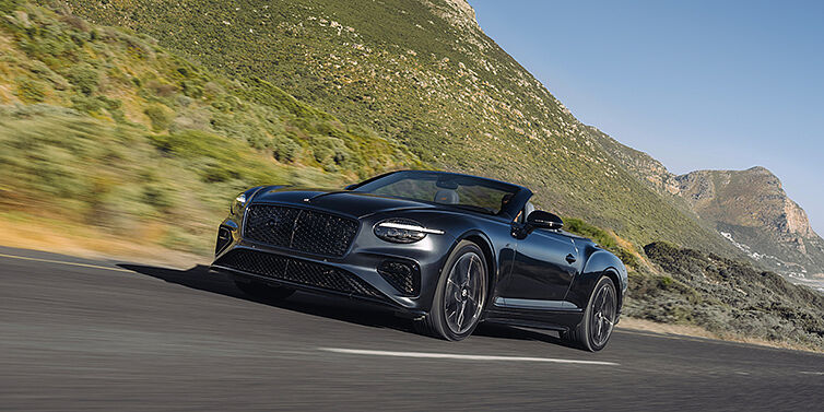Gohm Sportwagen GmbH | Bentley Singen Bentley Continental GTC S convertible in Thunder paint front 3/4 driving on mountain road