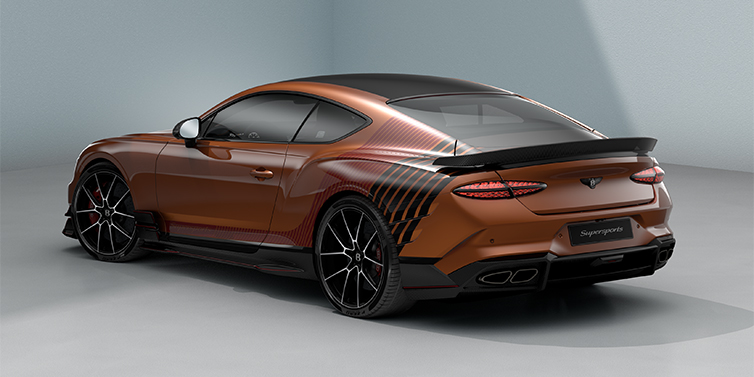 Gohm Sportwagen GmbH | Bentley Singen Bentley Supersports rear three quarter in "Meteorite" Design theme with Orange Flame paint and Beluga Black and Candy Red paint stripes across the rear haunch.