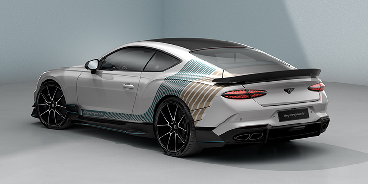 Gohm Sportwagen GmbH | Bentley Singen Bentley Supersports rear three quarter in "Snowstorm" Design theme with Snow Quartz paint and Topaz blue and Camel brown paint stripes across the rear haunch.