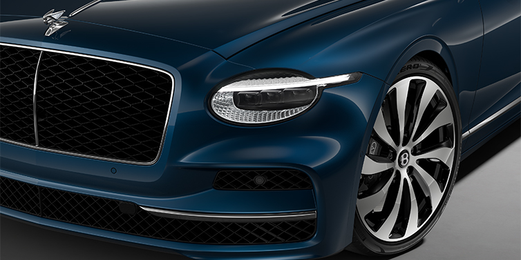 Gohm Sportwagen GmbH | Bentley Singen New Bentley Flying Spur sedan head lamp against Marlin blue paint with 22" Ten Spoke Black Painted and Bright Machined wheel