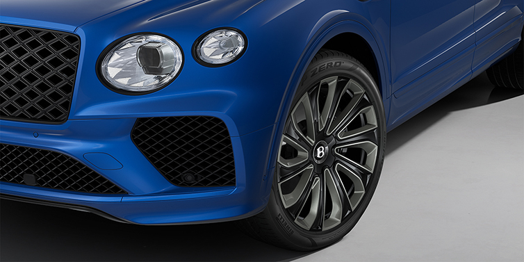 Gohm Sportwagen GmbH | Bentley Singen Bentley Bentayga Artenara Edition SUV front detail in Sequin Blue paint and 22" Mulliner Gloss Black wheels front 3/4