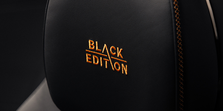 Gohm Sportwagen GmbH | Bentley Singen Bentley Continental GT coupe seat headrest Black Edition stitched emblem in Mandarin colour against Beluga black hide