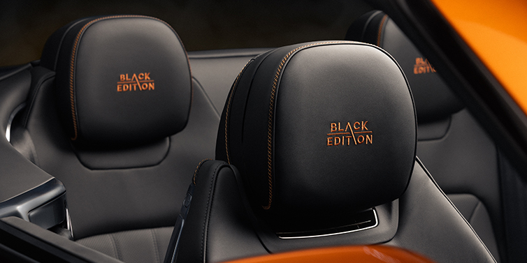 Gohm Sportwagen GmbH | Bentley Singen Bentley Continental GTC Black Edition convertible seat detail with Beluga black hide and Mandarin emblem stitching