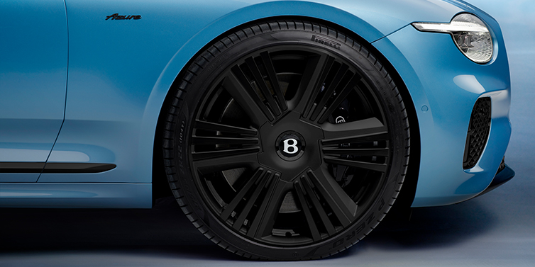 Gohm Sportwagen GmbH | Bentley Singen New Bentley Continental GTC Azure convertible front wheel detail with 22 inch black ten spoke wheel and dark chrome details against Light Windsor blue paint