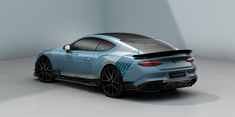 Gohm Sportwagen GmbH | Bentley Singen Bentley Supersports rear three quarter in "Daybreak" Design theme with Jetstream blue paint and Arctica white and Portofino blue paint stripes across the rear haunch.