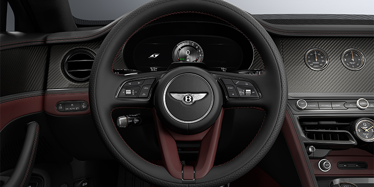 Gohm Sportwagen GmbH | Bentley Singen New Bentley Flying Spur S sedan steering wheel and dash in Cricket Ball red and Beluga black hides and High Gloss Carbon Fibre veneer
